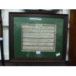 An oak framed glazed sampler dated 1898