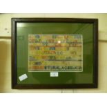 A framed and glazed sampler by Annie Stirk aged 10