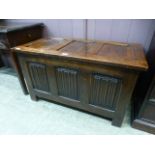 An early 20th Century oak panelled linen fold design coffer