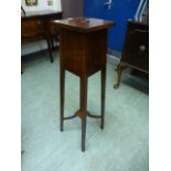 An Edwardian mahogany inlaid jardiniere stand with under tier