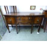 An early 20th century mahogany bow fronted sideboard having two drawers flanked by cupboard doors