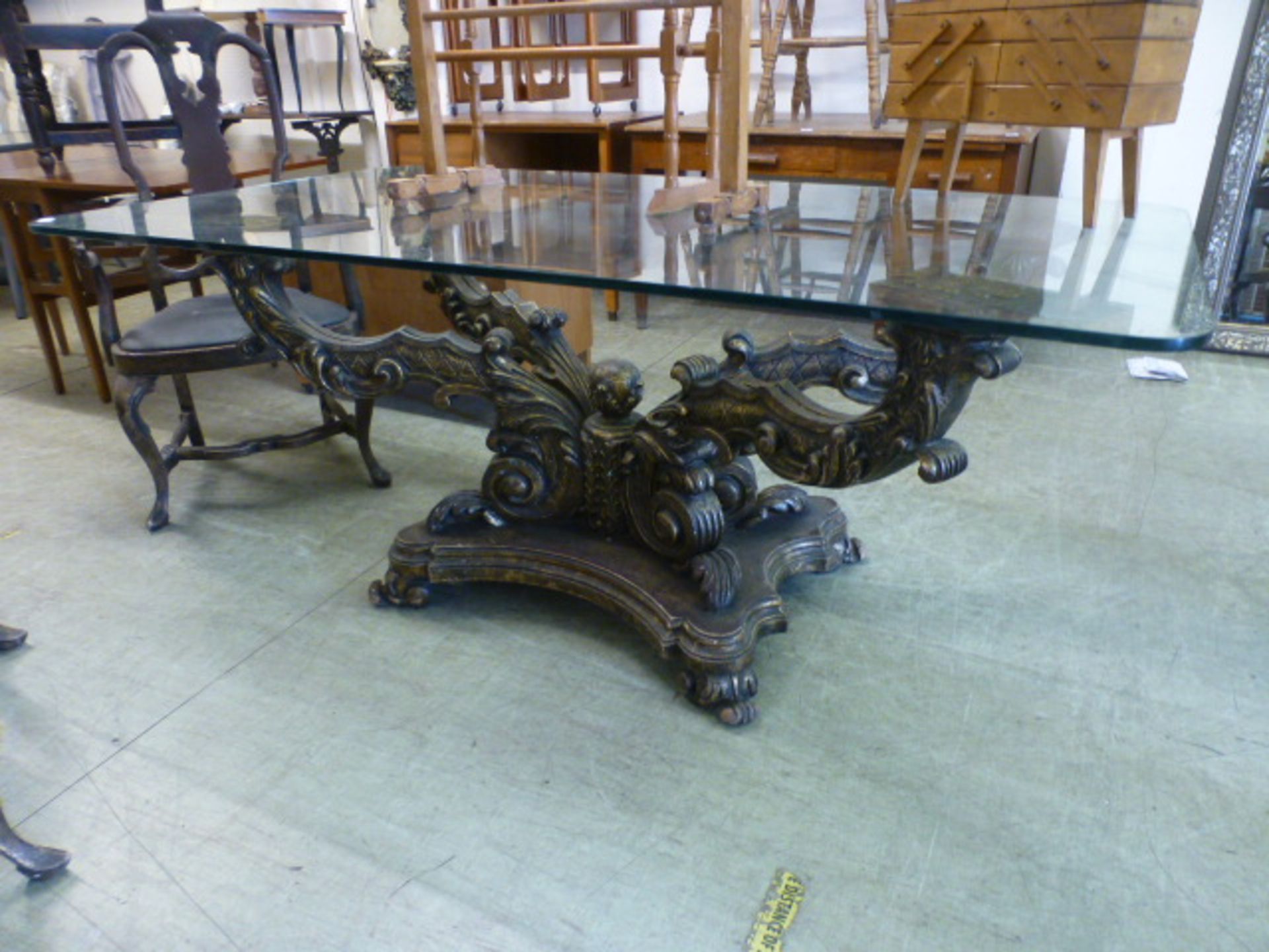 An Italian gilt wood four branch based glass top dining table