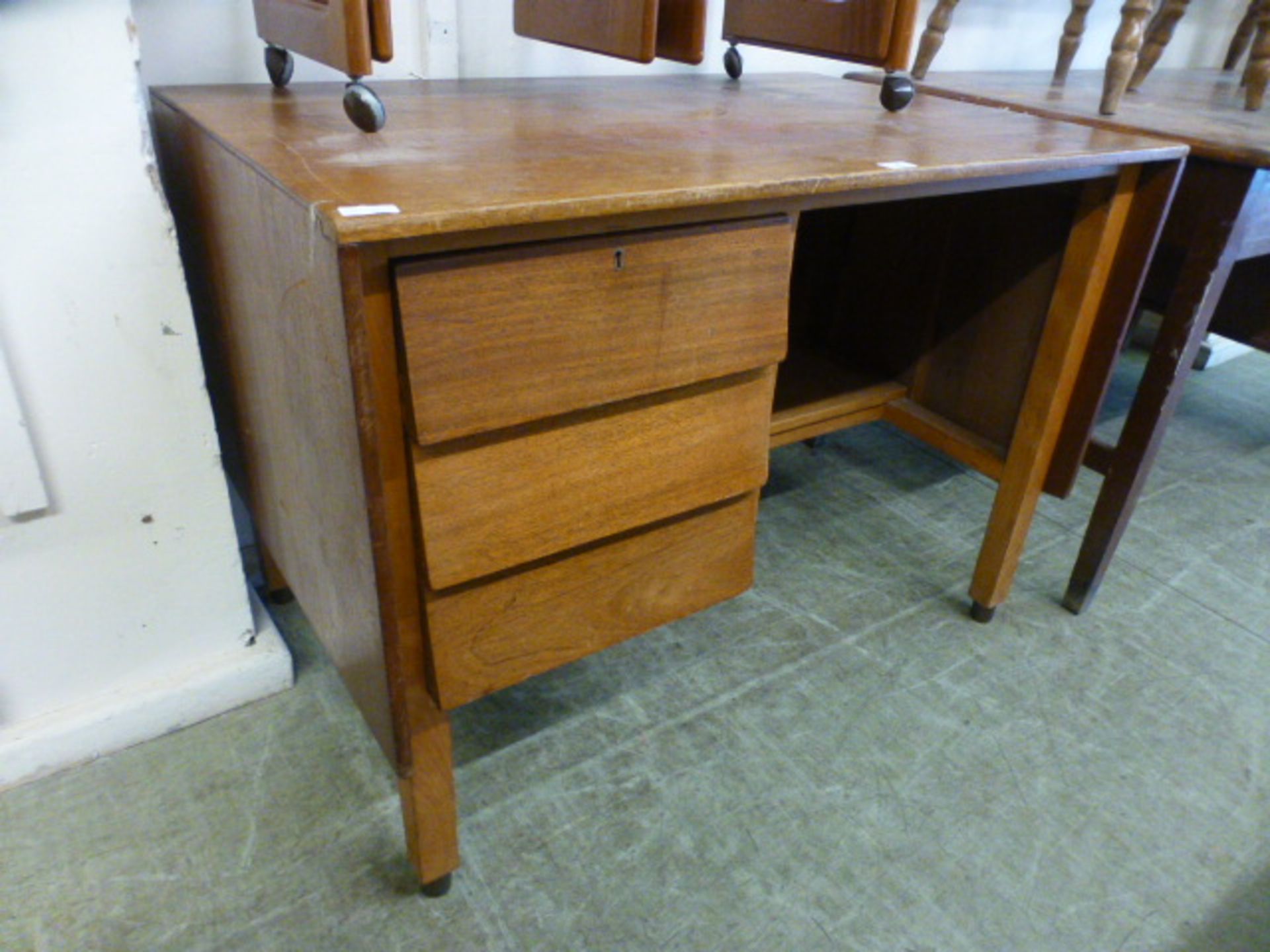 A mid-20th century teak desk with three drawers and hidden cupboard by Remploy CONDITION