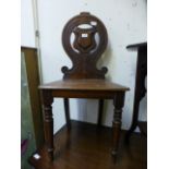 A late Victorian mahogany shield back hall chair