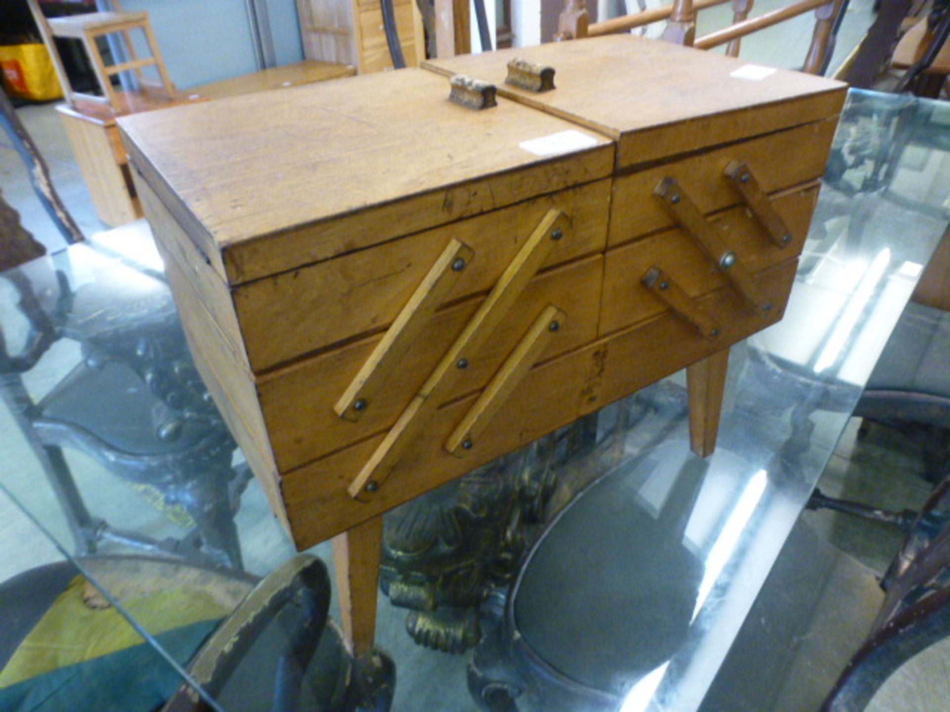 An early 20th century cantilever sewing box with contents