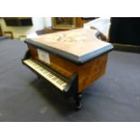 A miniature music box in the form of a grand piano