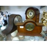 A oak cased Napoleon hat mantle clock together with a mahogany mantle clock and one other