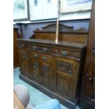 An early 20th century oak sideboard having three drawers above a single drawer above three cupboard