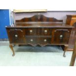 An early 20th century mahogany sideboard having two drawers flanked by cupboard doors supported on