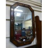 An early 20th century oak framed bevel glass wall mirror