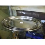 Four stainless steel trays marked Firth Staybrite Keswick