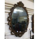 An ornate and gilt framed wall mirror