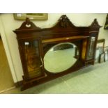 An early 20th century mahogany over mantle mirror having a bevelled glass centre mirror flanked by