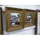 A pair of ornate gilt framed mirrors