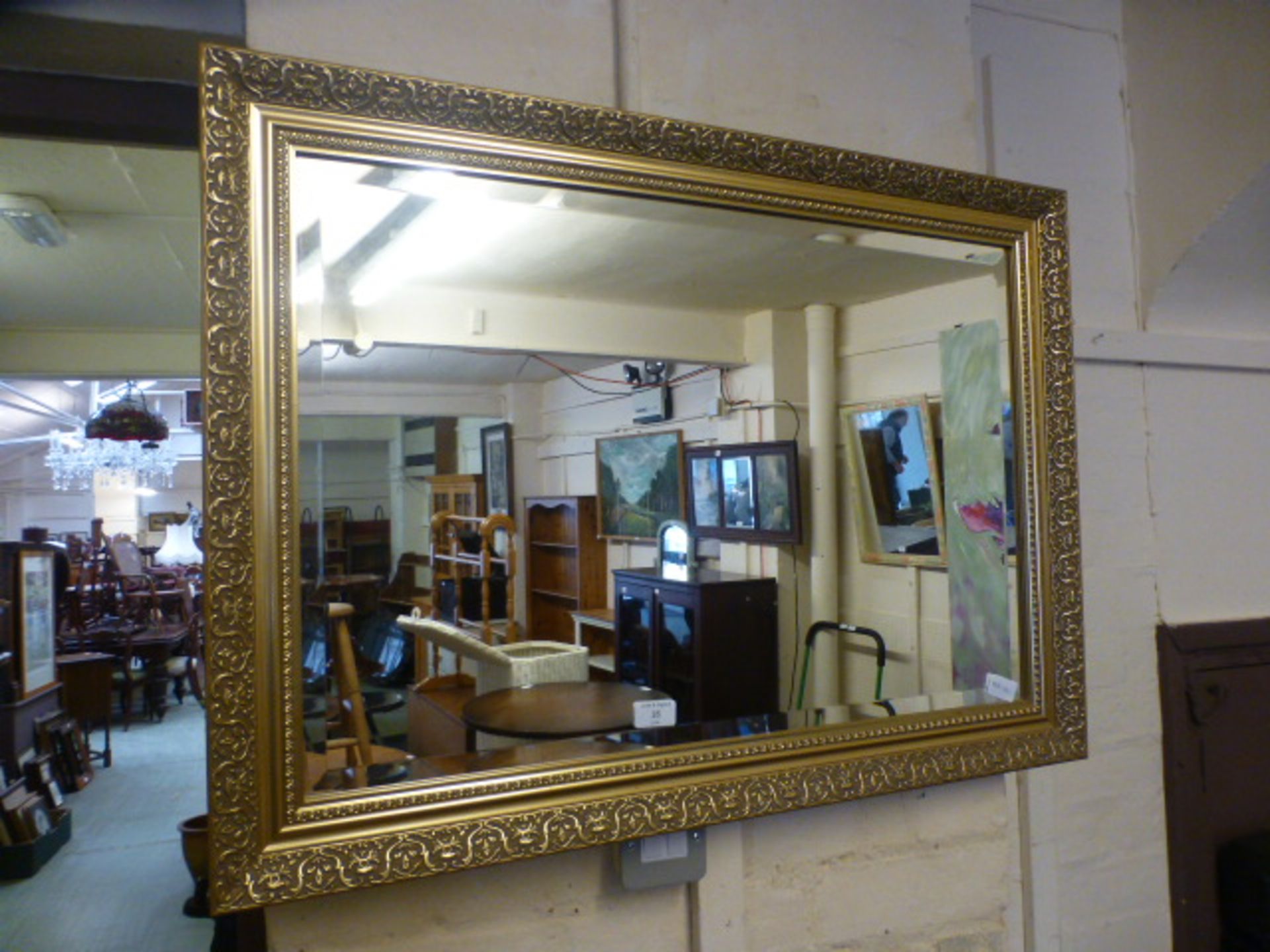 An ornate gilt framed bevelled glass mirror