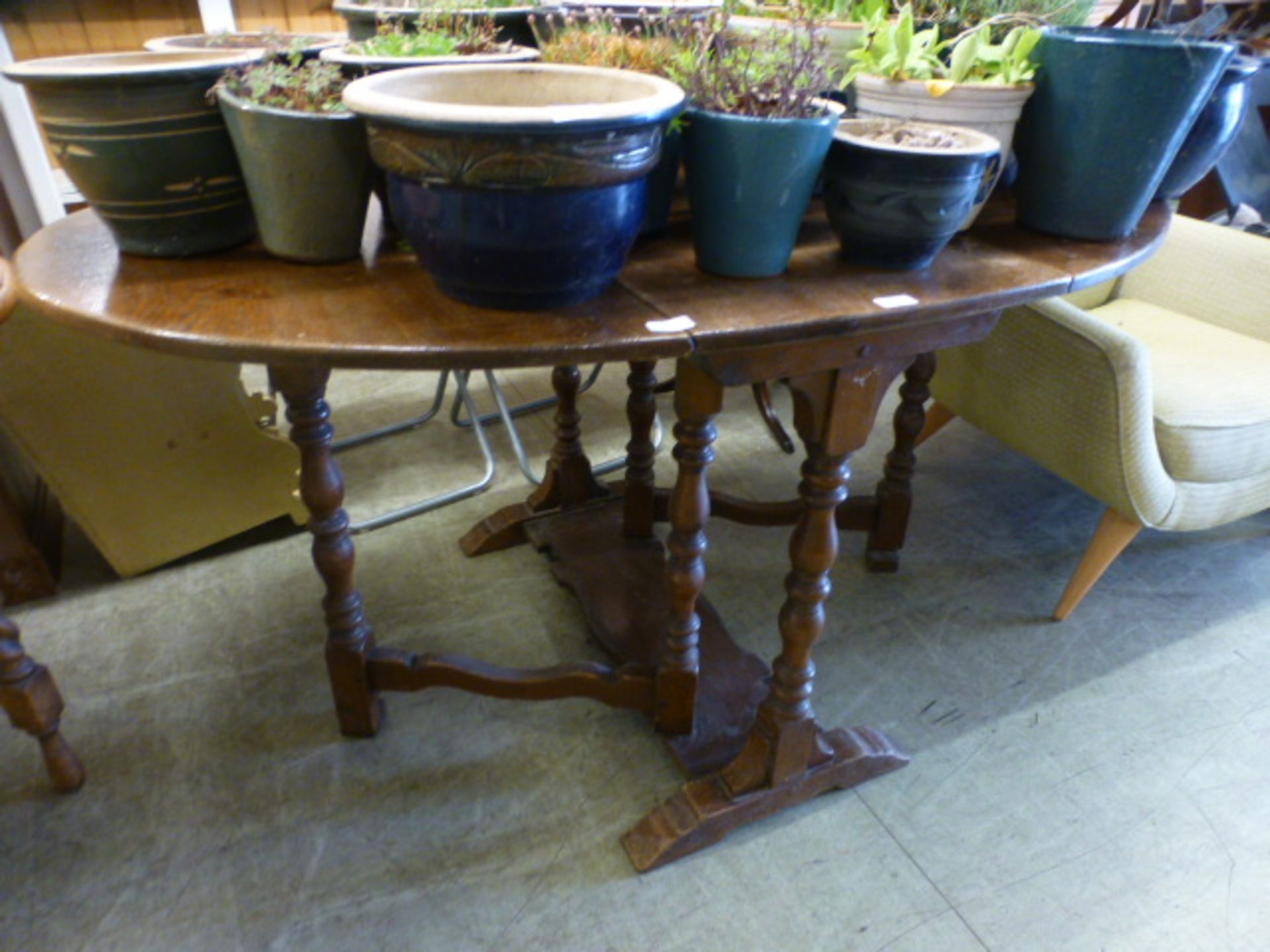 An early 20th century oak gate leg table