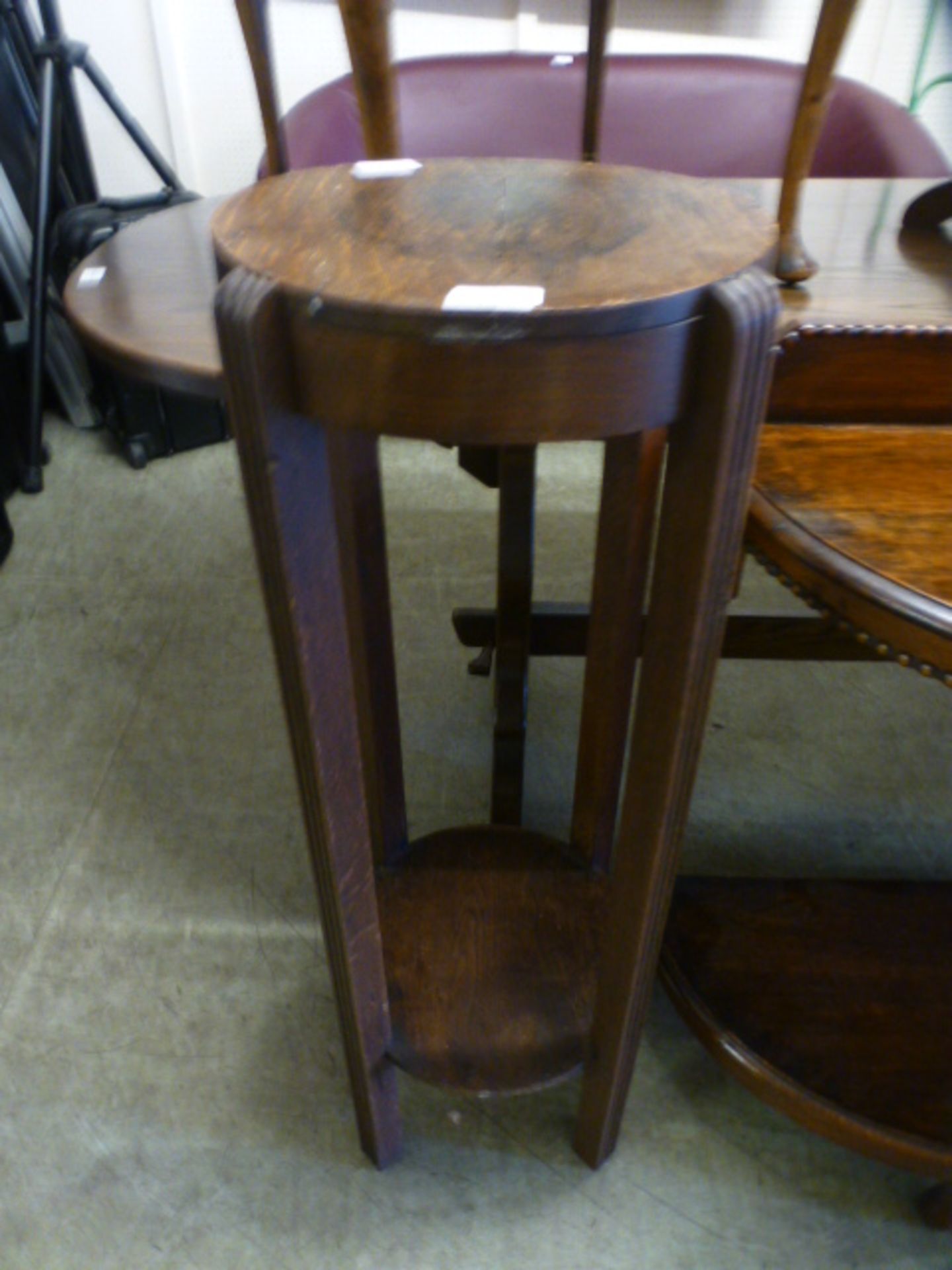 An early 20th century oak jardiniere stand