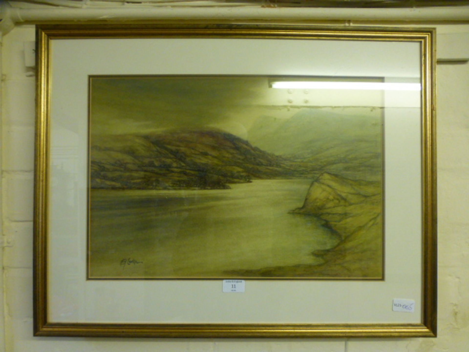 A framed and glazed watercolour of mountainous lake scene signed Caulkin