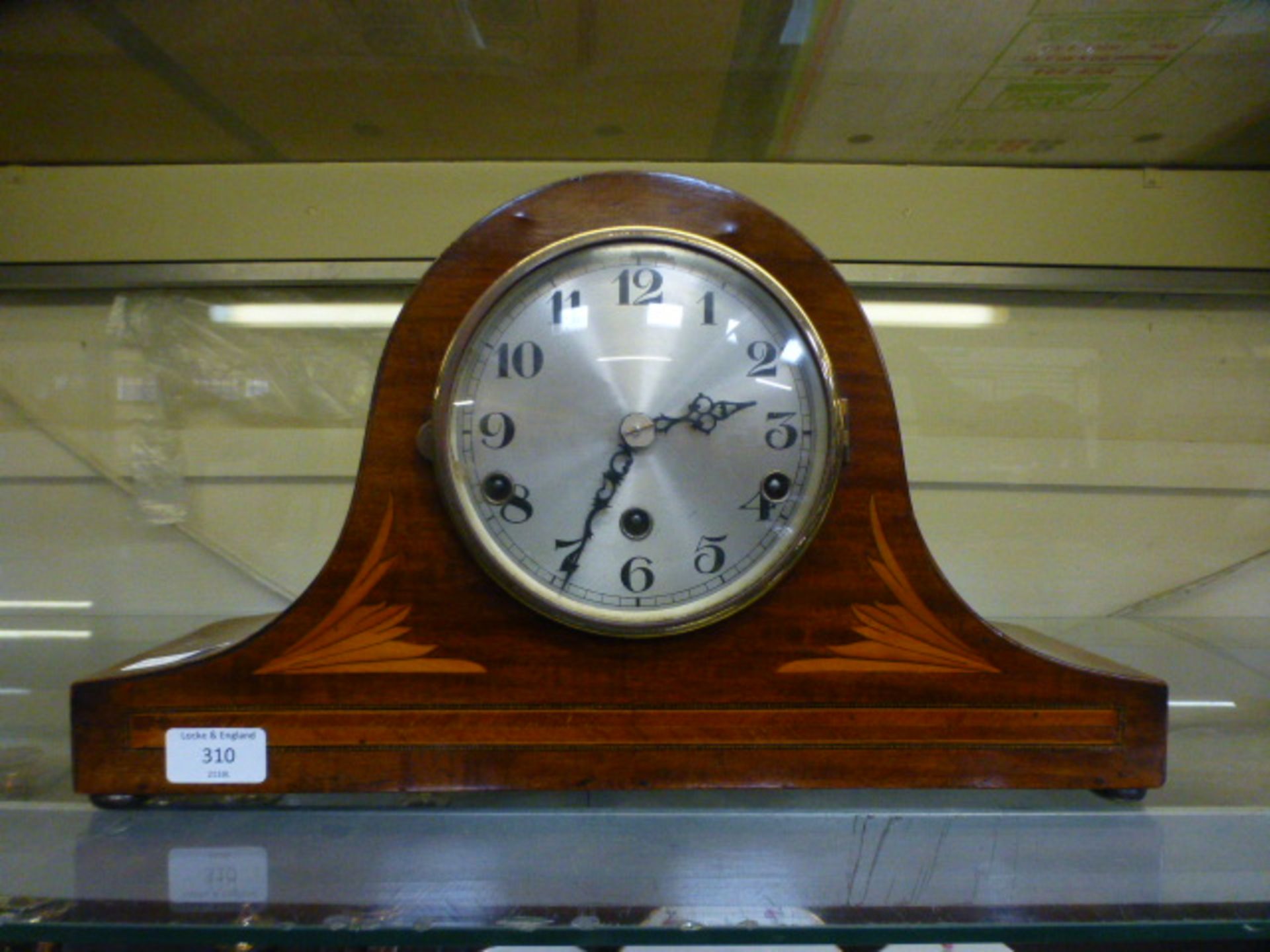 An early 20th century mahogany inlaid mantle clock having Westminster chimes