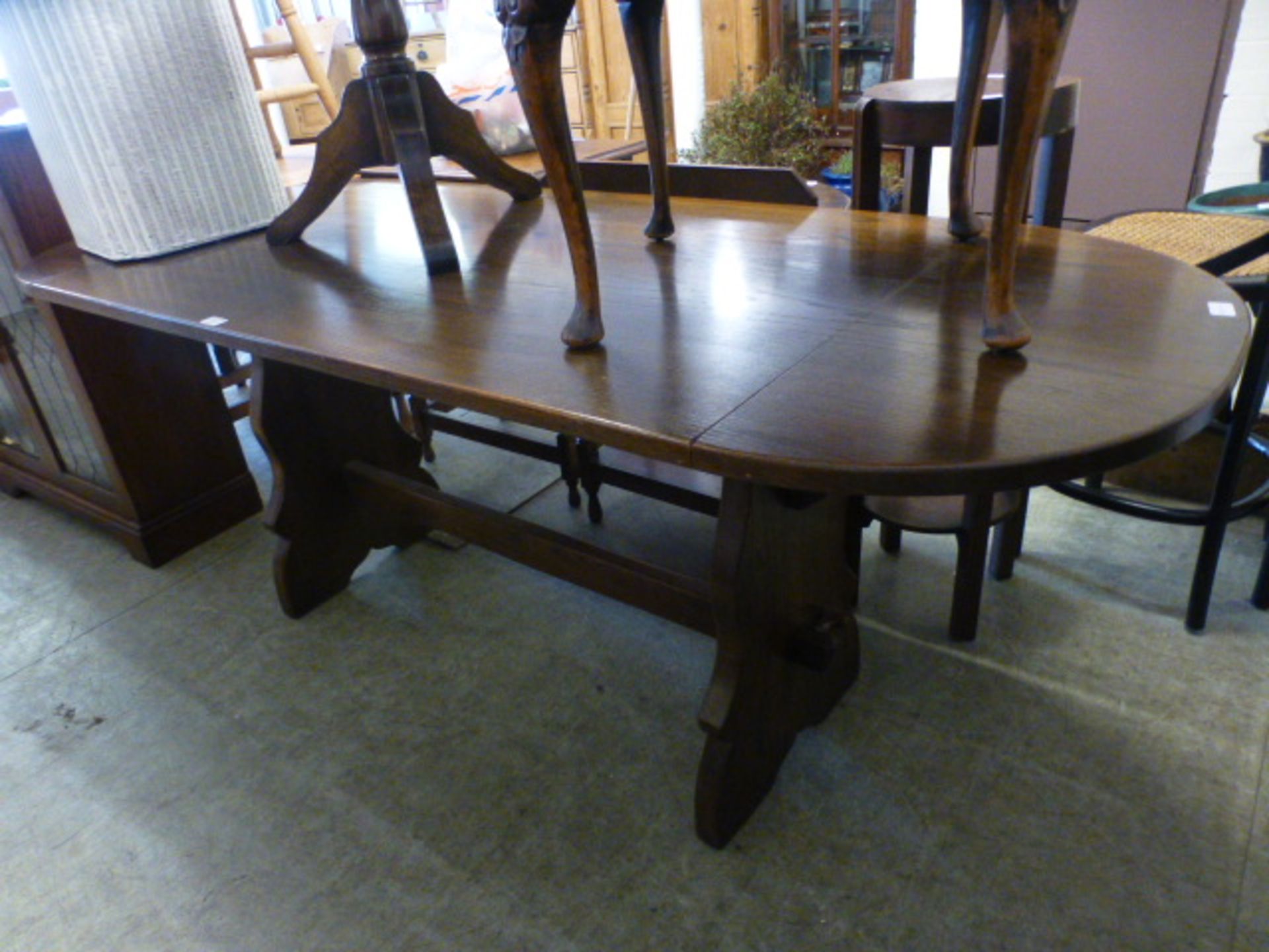 A modern oak drop leaf dinning table with trestle support