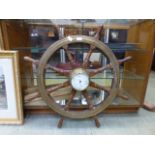A barometer mounted on a ships wheel A/F