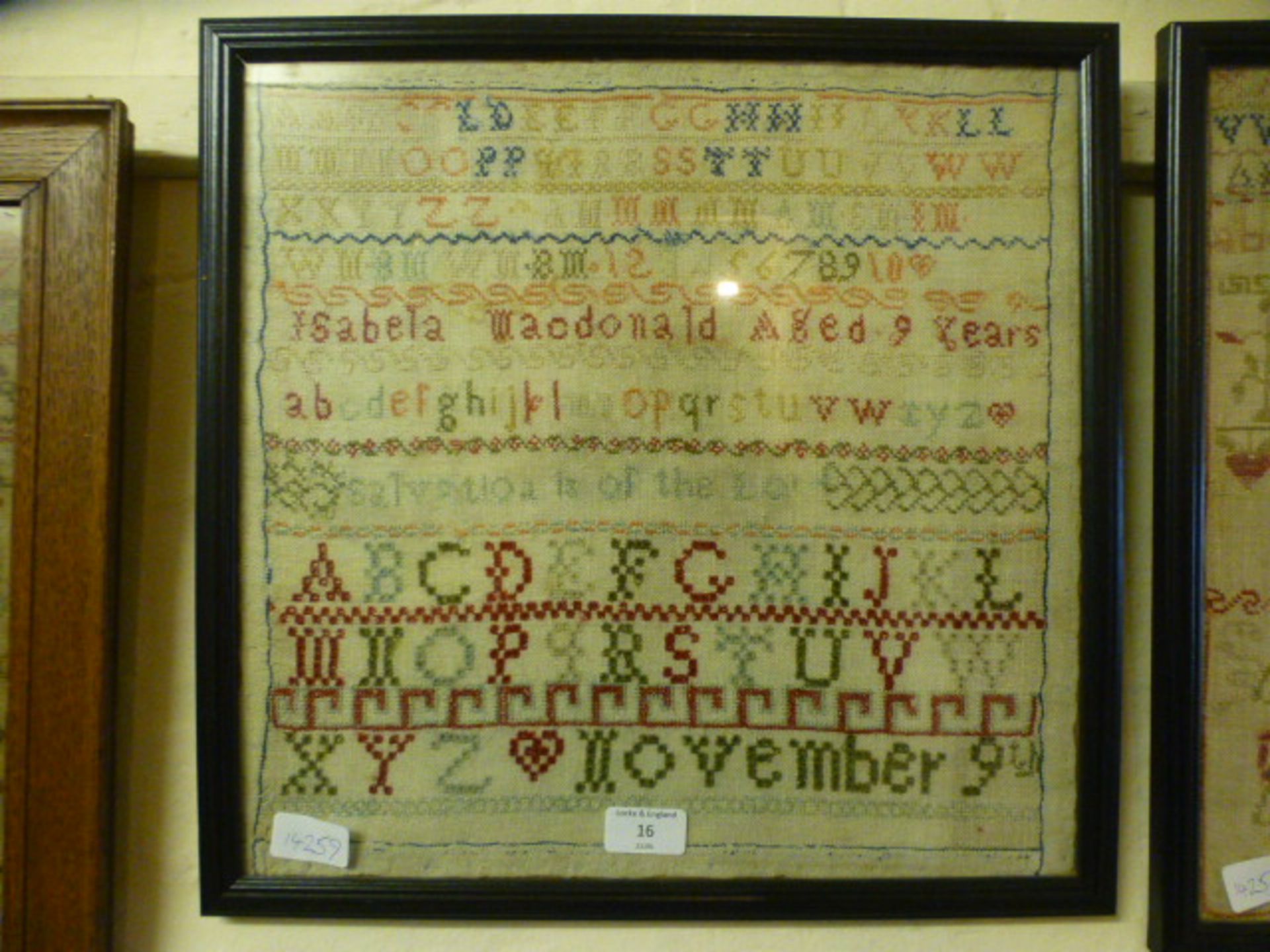 A framed and glazed sampler by Isabella McDonald aged nine