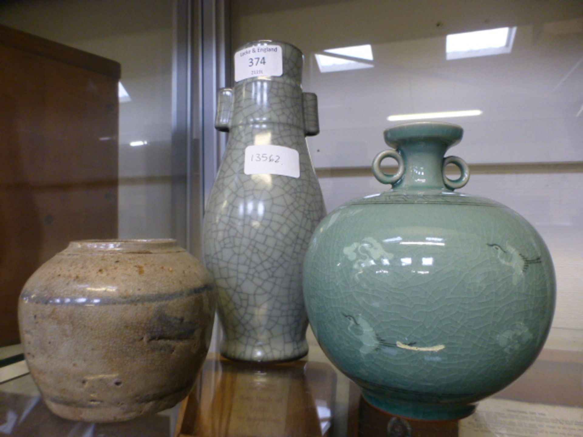 An 18th century Chinese ceramic pot together with a Chinese celadon glazed vase and a crackle