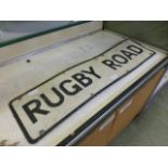 A metal road sign 'Rugby Road'