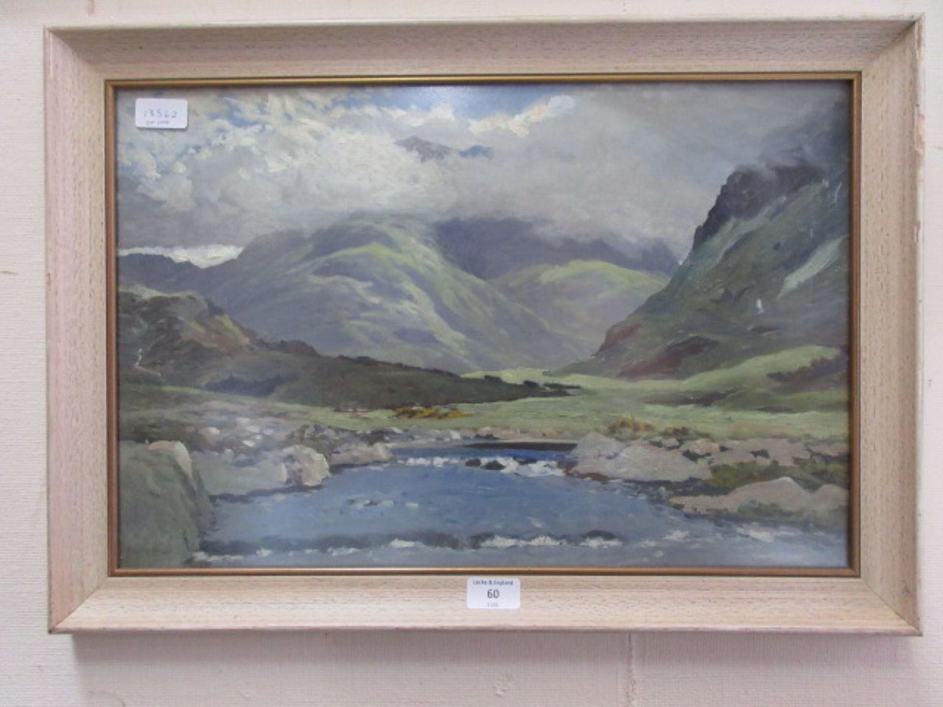 A framed and glazed oil of mountainous lake scene signed Harrison
