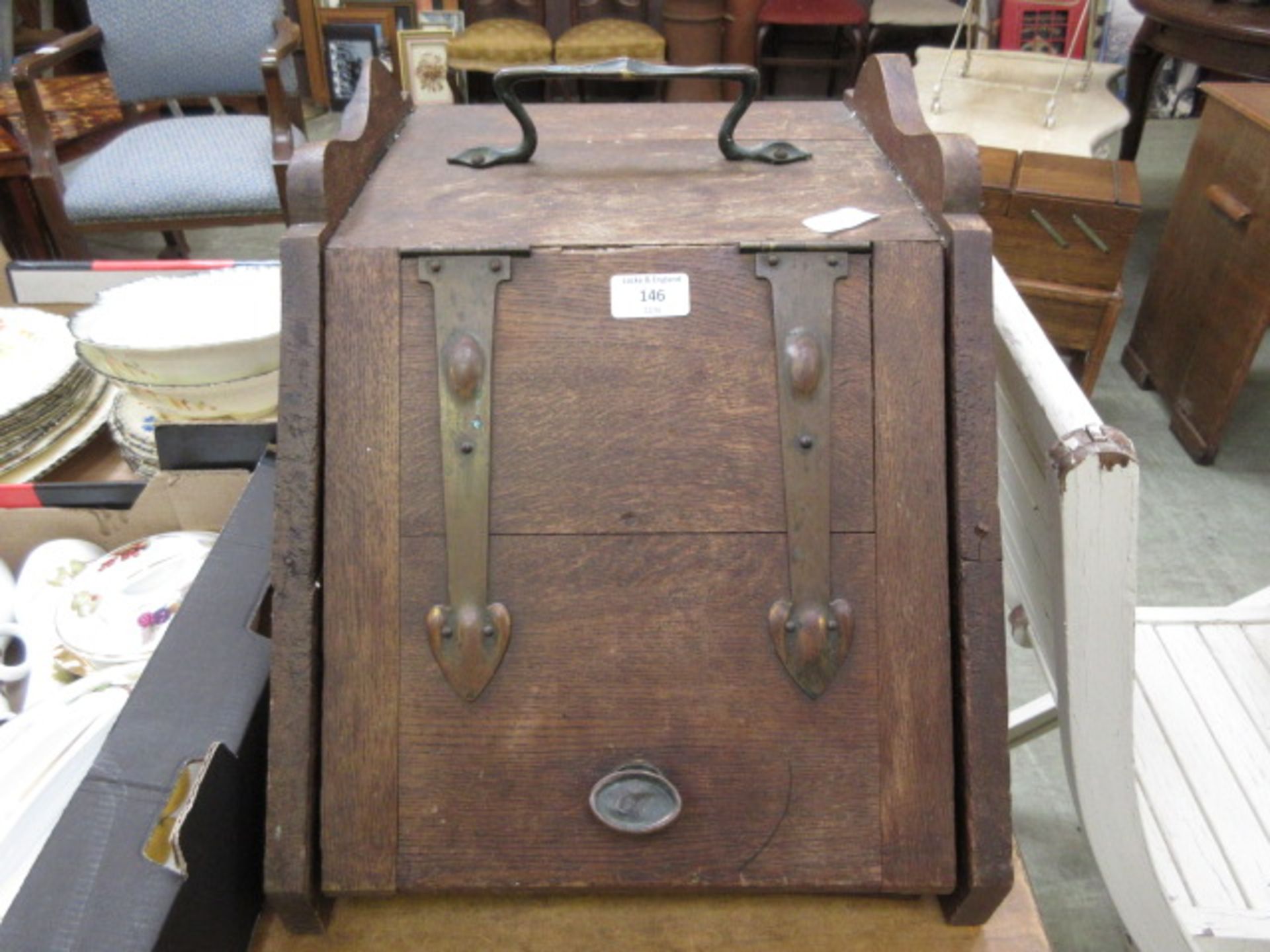 An early 20th century oak coal scuttle with copper fittings