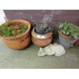 Three terracotta pots along with two garden ornaments and green pants