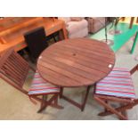 A teak folding garden table along with a pair of matching chairs