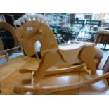 A wooden rocking horse on bow base