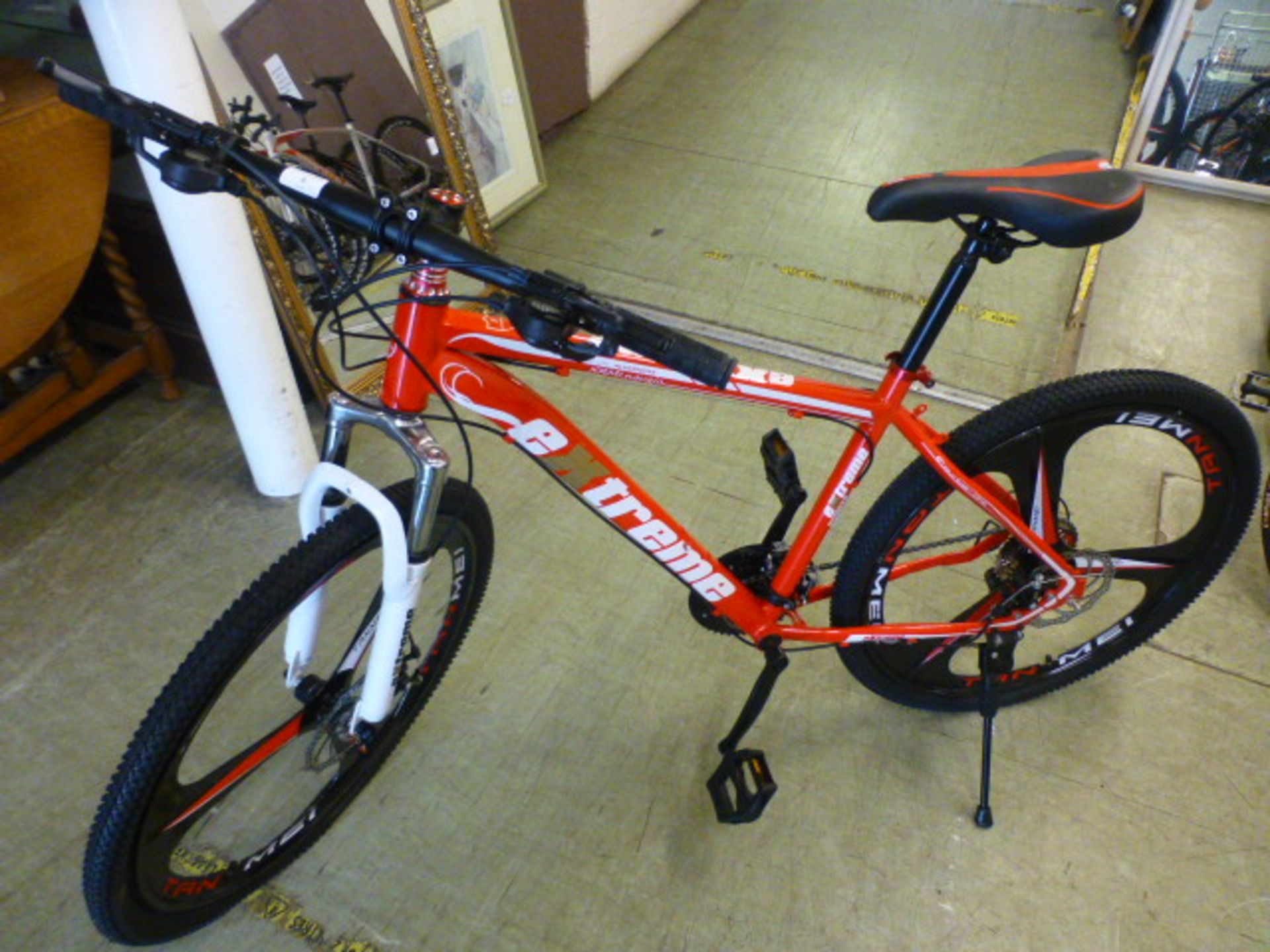 An Extreme red/white 27 speed mountain bike with 26'' wheels