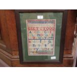 A framed and glazed sampler