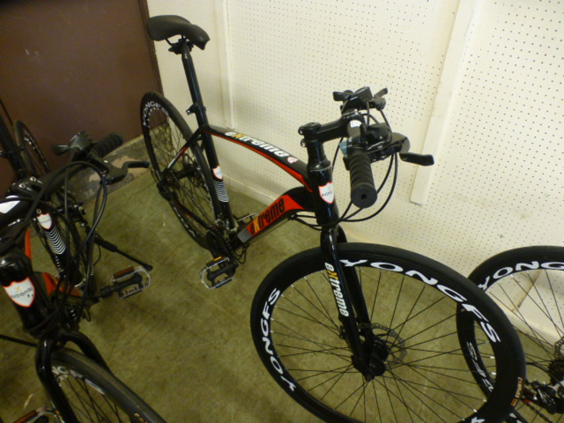 An Extreme black/red road bike with Shimano gears and 700c wheels