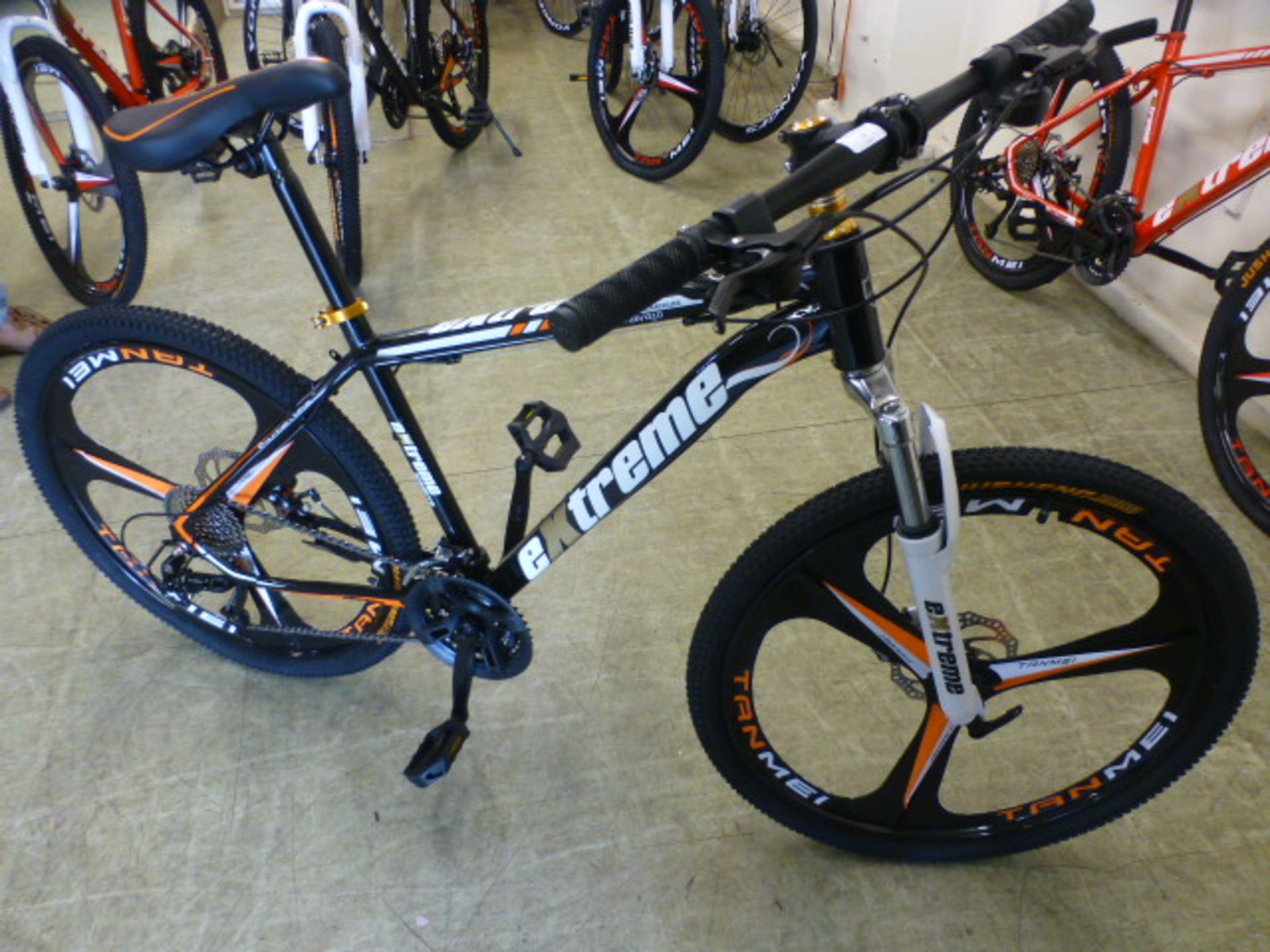 An Extreme black/orange 27 speed mountain bike with 26'' wheels