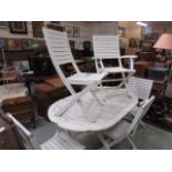 A flaky white painted teak garden table along with a set of five matching chairs