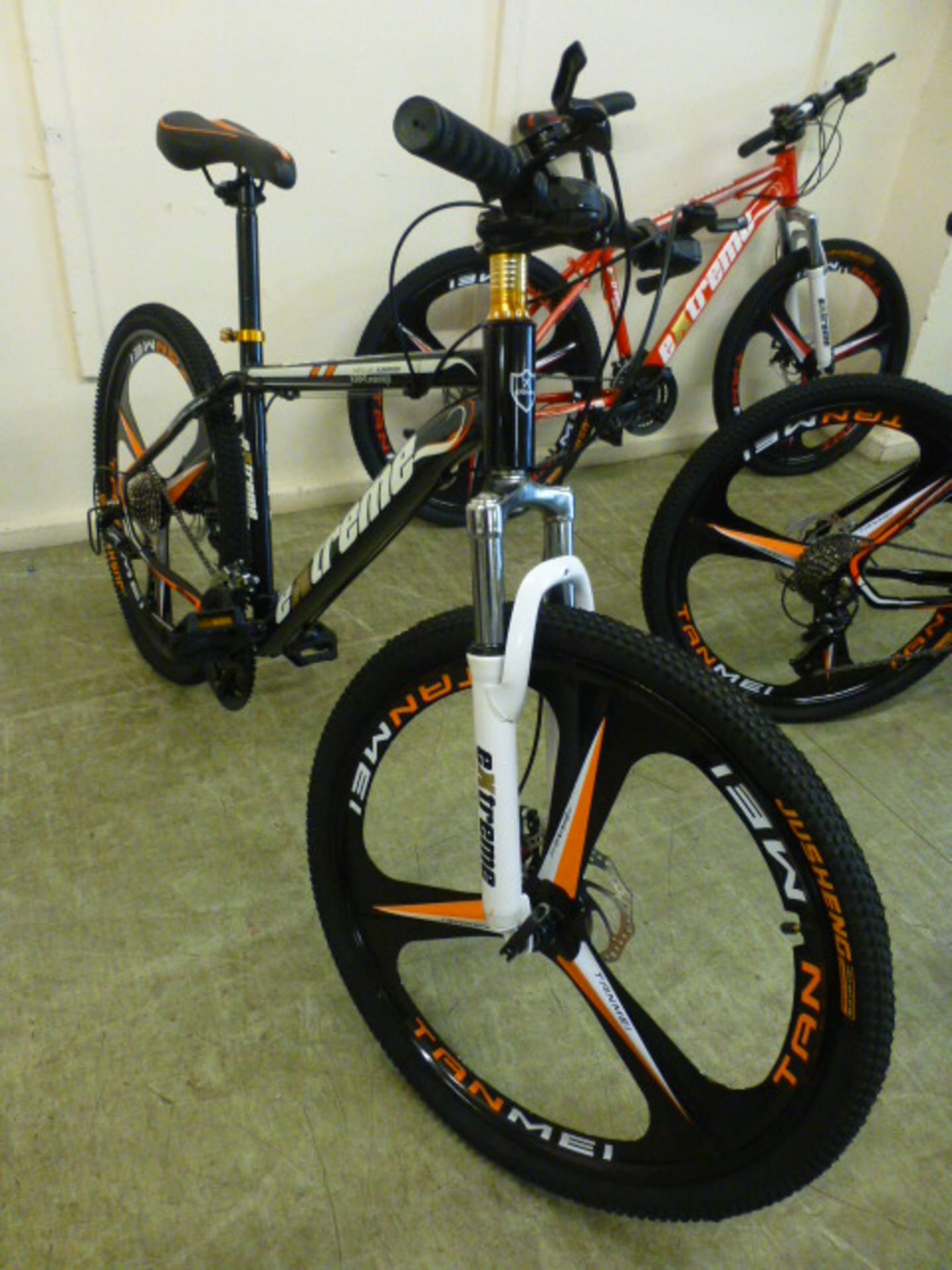 An Extreme black/orange 27 speed mountain bike with 26'' wheels