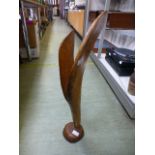 A carved wooden abstract statue