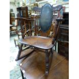 An early 20th century spindle back rocking chair