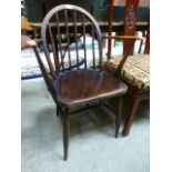 A dark Ercol spindle back open armchair