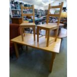 A modern kitchen table along with two chairs