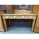 An early 20th century pine wash stand having two drawers on turned supports CONDITION