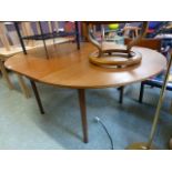 A mid-20th century teak extending dining table