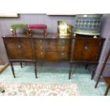 A reproduction mahogany effect serpentine fronted sideboard having three drawers flanked by