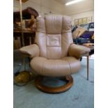 A tan and leather upholstered swivel relaxing chair by Stressless