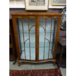 A mid-20th century glazed display cabinet