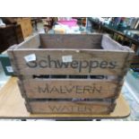 A Schweppes wooden bottle carrier