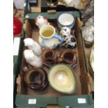 A tray containing an assortment of ceramic ware to include fireside dogs,